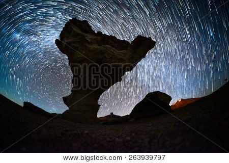 Starry sky with the star trails like comets and rock formation named Arbol de Piedra (Stone Tree) in Eduardo Avaroa Andean Fauna National Reserve of Sur LÃ­pez Province, Bolivia