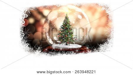 Digital composite of Christmas snowflake border with Christmas tree in snow globe