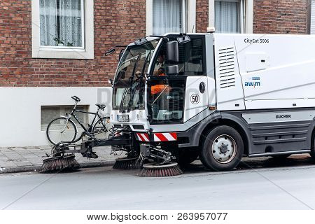 Germany, Muenster, October 5, 2018: A Special Truck Or Street Cleaning Vehicle Rides Along The Road 