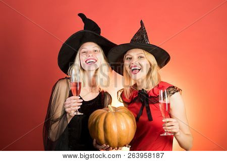 Laughing Funny Sister Twins Girls In Witches Costumes In Halloween. Two Happy Young Women In Black A