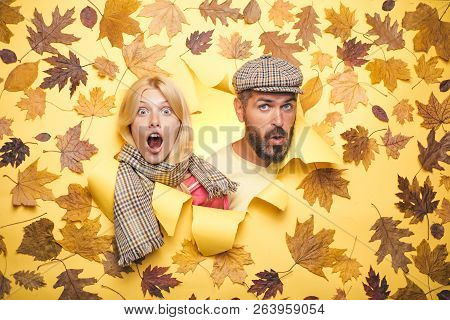 Surprised Couple On Autumn Clothes Discounts, Man With Beard And An Attractive Girl In Yellow Backgr
