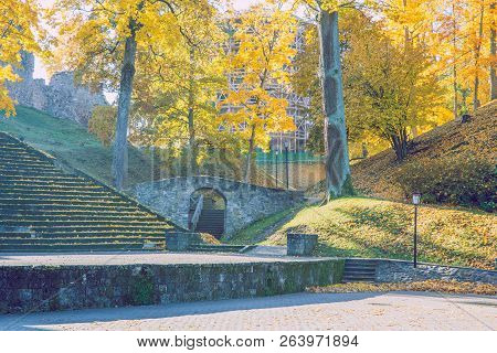 City Cesis, Latvia. Old Casttle Park At Autumn. Yellow Leafs, Ruins And Architecture. Historic Build