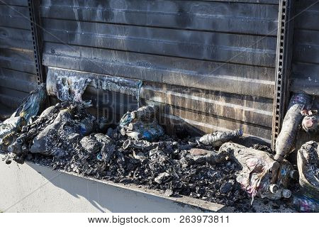 Close Up Damaged Industry Supermarket Metallic Facade After Arson Fire With Burn Debris Of Plastic B