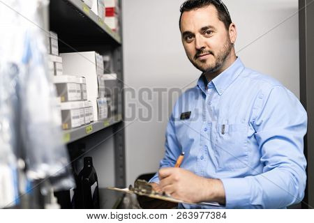 Merchandiser Checking Products Availibility For Car Repair