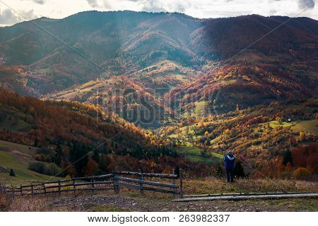 Undefined Person On The Edge Of A Hill Looking In To The Distant Rural Valley. Beautiful Nature Scen
