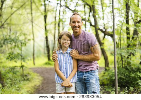 Father Having Fun In Forest With His Daughter
