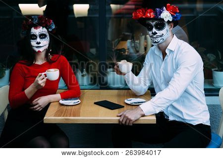A Couple, Wearing Skull Make-up For. All Souls Day. Boy And Girl Sugar Skull Makeup.painted For Hall
