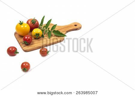 Organic Ripe Small Red And Yellow Tomatoes On Wooden Cutting Board (plate) Isolated On White Backgro