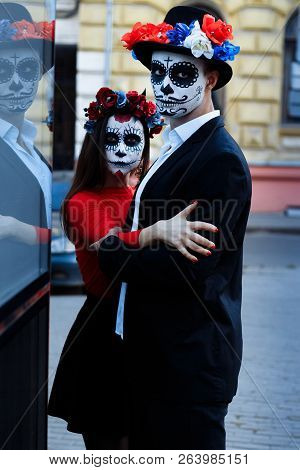A Couple, Wearing Skull Make-up For. All Souls Day. Boy And Girl Sugar Skull Makeup.painted For Hall