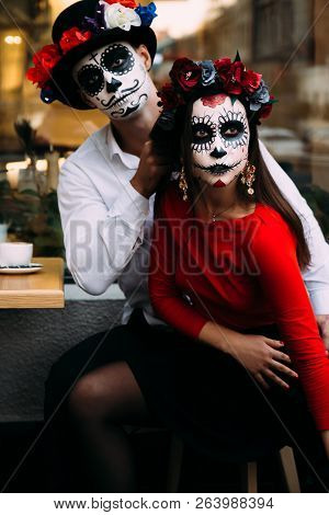 A Couple, Wearing Skull Make-up For. All Souls Day. Boy And Girl Sugar Skull Makeup.painted For Hall