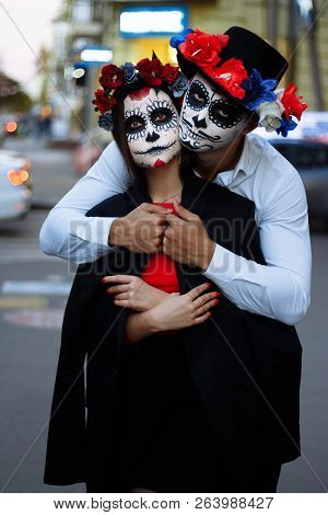A Couple, Wearing Skull Make-up For. All Souls Day. Boy And Girl Sugar Skull Makeup.painted For Hall