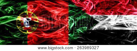 Portugal Vs Sudan, Sudanese Smoke Flags Placed Side By Side. Thick Colored Silky Smoke Flags Of Port