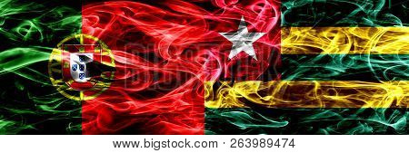 Portugal Vs Togo, Togolese Smoke Flags Placed Side By Side. Thick Colored Silky Smoke Flags Of Portu