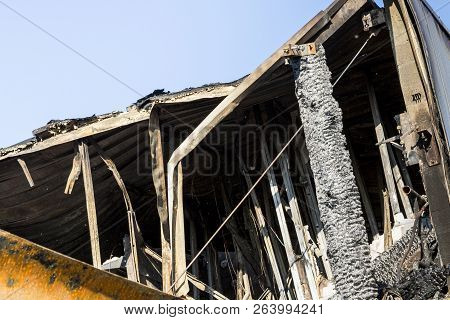 Damaged Roof Industry Supermarket After Arson Fire With Burn Debris Of Twisted Metal Structure After