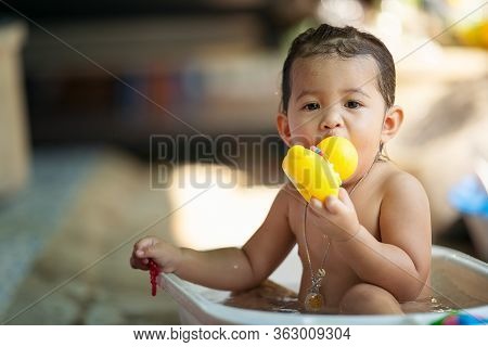 Bath Time Is Fun. Selective Focus Image Of A Cute Little Girl Taking A Bath And Playing With Rubber 