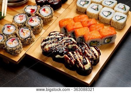 Tasty And Delicious Hot And Cold Sushi Rolls On The Table. Different Sushi - Rolls With Sauce On The