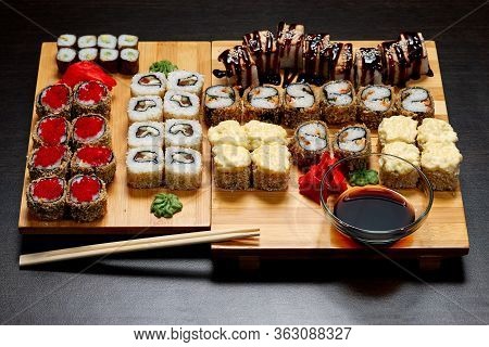 Tasty And Delicious Hot And Cold Sushi Rolls On The Table. Different Sushi - Rolls With Sauce On The