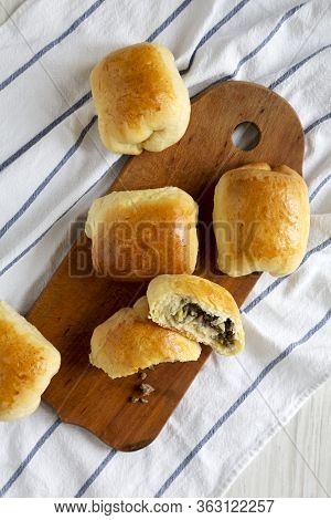 Home-baked Beef Russian Bierocks On A Rustic Wooden Board On Cloth, Top View. Flat Lay, Overhead, Fr