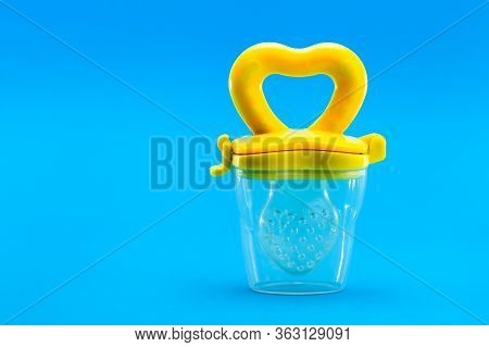 Fruit Feeder For Feeding Weaned Babies Isolated On A Blue Background With A Copy Space, Nobody.