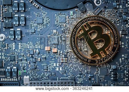 Bit Coin Gold Cryptocurrency On Computer Electronic Circuit Board Motherboard. Litecoin, Ethereum Cr