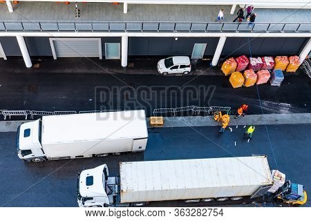 Asphalt Road At Shipping/ Shipment/ Cargo Delivery Port. White 10 Wheeler Freight Truck And 18 Wheel