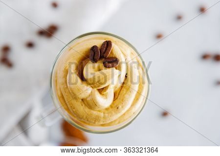 Top View Close-up On A Glass Of Cold Coffee Dalgon Drink Decorated With Grains. Copy Space