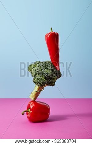 Fresh Chili Pepper On Broccoli And Bell Pepper On Blue And Pink