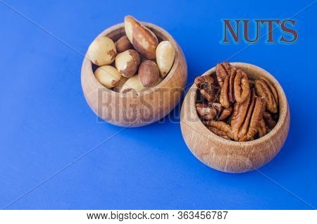 Pekan And Brazil Nuts On Blue Background. Healthy Food