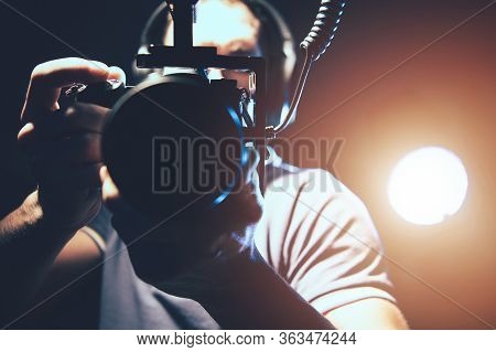 Videographer With Professional Dslr Camera In Hands Taking Handheld Shots For His Documentary Video 