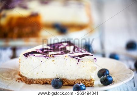 A Slice Of Delicious Homemade Blueberry Marble Cheesecake With Graham Cracker Crust And Fresh Bluebe
