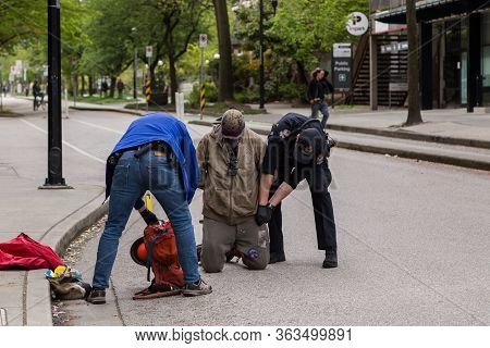 Downtown Vancouver, Bc, Canada - Apr 26, 2020: An Antifa Protester Becoming Combative With A Police 
