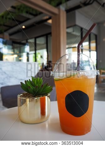 Cold Iced Tea With Lemon And Straw In Takeaway Plastic Cup. Cold Refreshing Cocktails In Take Away G
