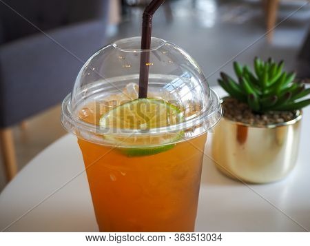 Cold Iced Tea With Lemon And Straw In Takeaway Plastic Cup. Cold Refreshing Cocktails In Take Away G