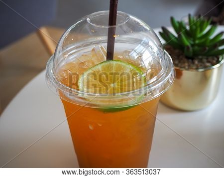 Cold Iced Tea With Lemon And Straw In Takeaway Plastic Cup. Cold Refreshing Cocktails In Take Away G