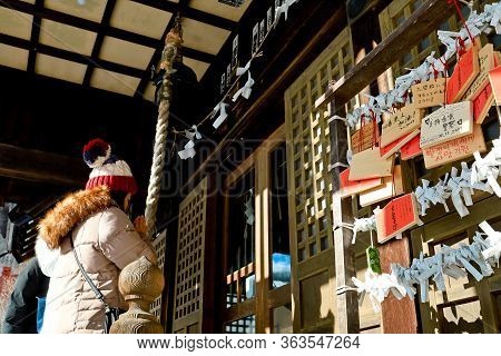 Noboribetsu, Hokkaido, Japan - December 2019 : Unidentified Girl Wish For Couple At Yuzawa Shrine In