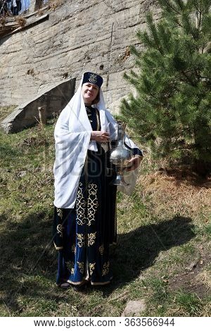 Woman Posing With Metal Jug In Karachai Clothes