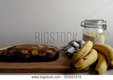 Homemade Banana Bread Over A Wooden Table With Bananas As Decoration With Copy Space