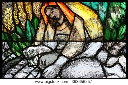 HOHENBERG, GERMANY - MAY 06, 2014: To live and work, detail of stained glass window by Sieger Koder in St. James church in Hohenberg, Germany