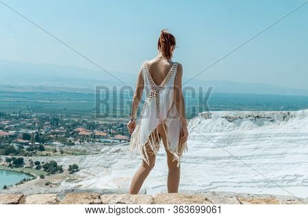 Woman Looks On Pamukkale Mountain In Turkey. Panoramic View. Sunny Day.