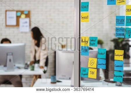 Various Post It Notes Of Business Strategy Wording Over The Glass Wall In Office Or Coworking Space,