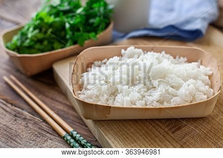 Boiled Rice On A Bambu Bowl With Parsley