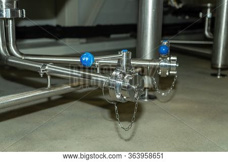 Beer Equipment Inside The Brewery. Gates And Taps.