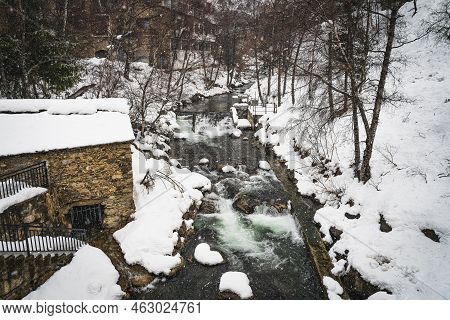 Valira Dorient River In Winter With Snow Banks In El Tarter Mountain Village In Pyrenees Mountains, 