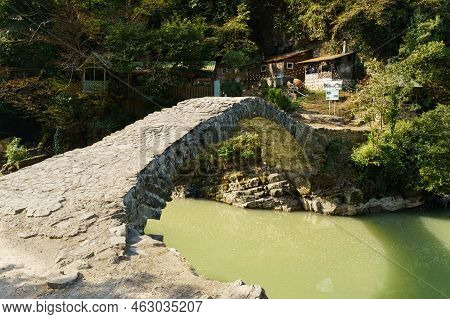 View Of Tamara Bridge And Mountain River In Makhuntseti, Georgia. Travel And Vacation Concept.