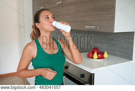 Morning Portrait Of Young Woman Drinking Whey Protein Beverage. Home Fitness Girl Drinks Kefir From 