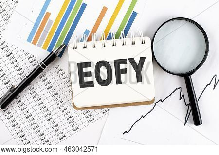 Eofy Text On Notebook On Graph Background With Pen And Magnifier