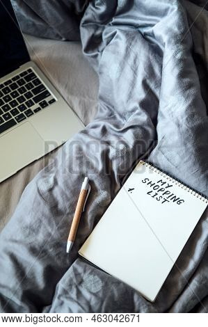 Frugal Living Tips, Save Money Concept With Shopping List In Notebook Near Laptop And Tea Coffee Cup
