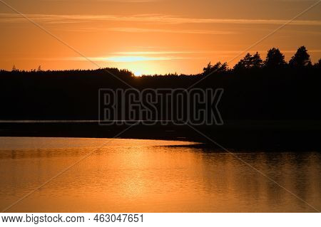 Sunset With Reflection On A Swedish Lake In Smalland. Romantic Evening Mood. Landscape Shot From Sca
