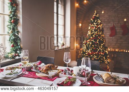 Beautiful Table Setting For Family Christmas Dinner At Home With Christmas Lights And Decorations In