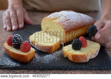 Close-up On Woman Hands Decorating The Homemade Plumcake Ready To Eat. Cooking At Home. Delicious He